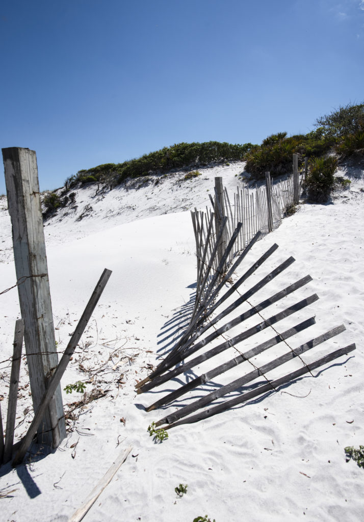 broken beach fence