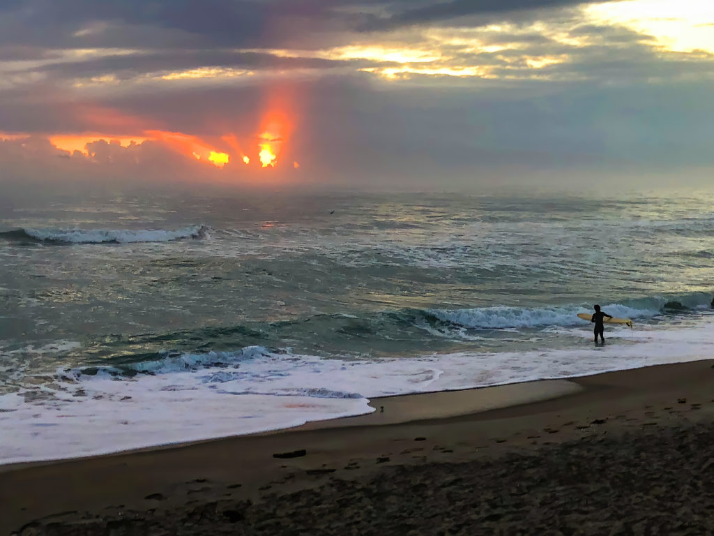 lone surfer sunrise